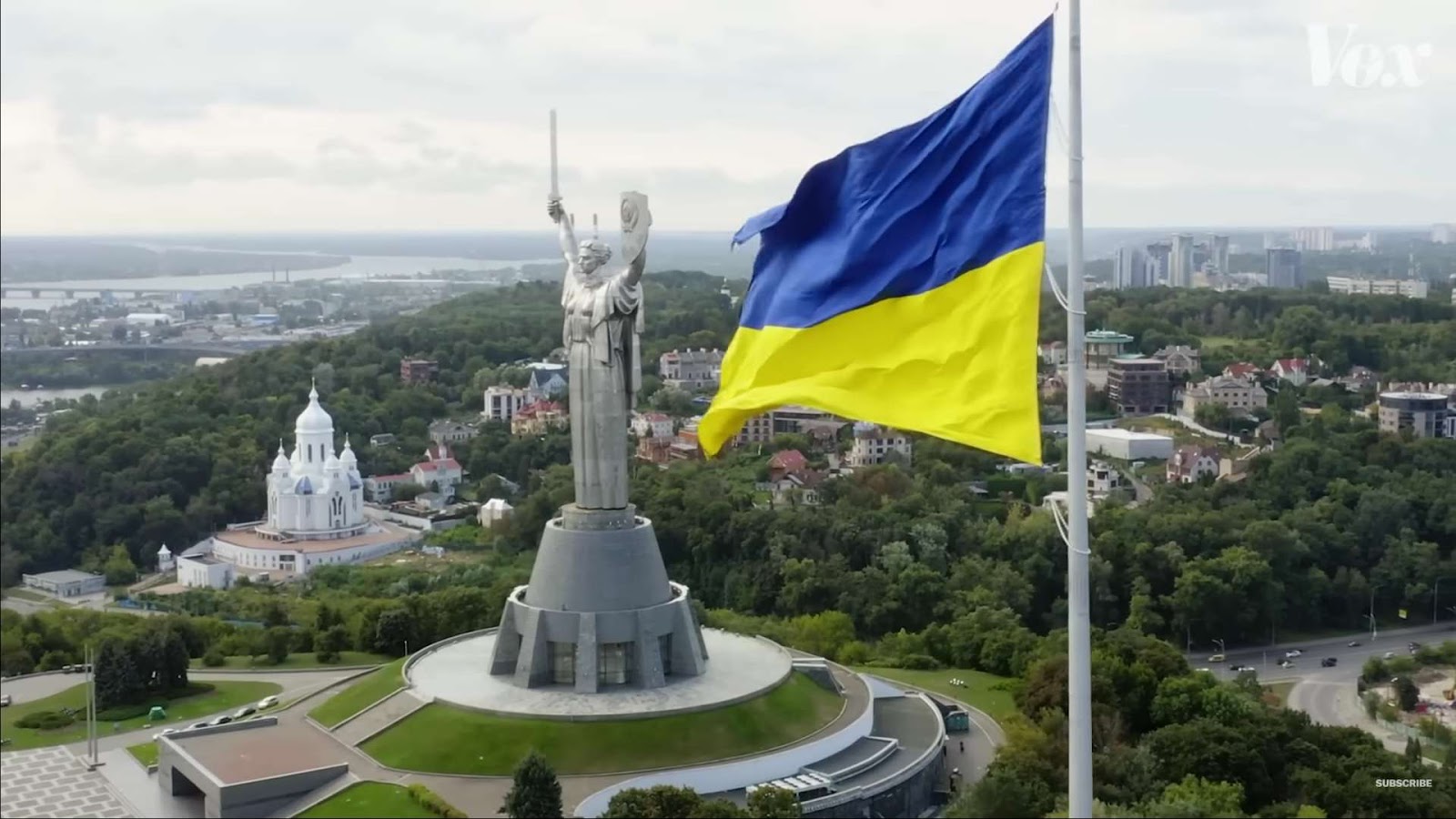 Ukrainian flag against the monument